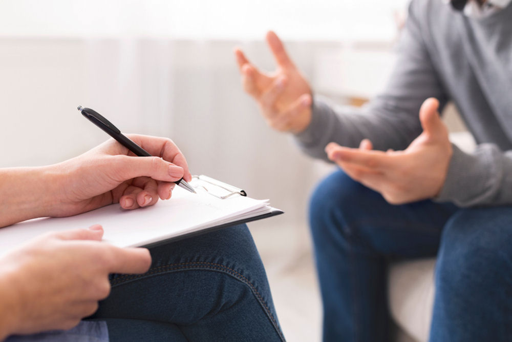 Man gesturing while telling a psychologist about depression treatment in Sonoma County, California.